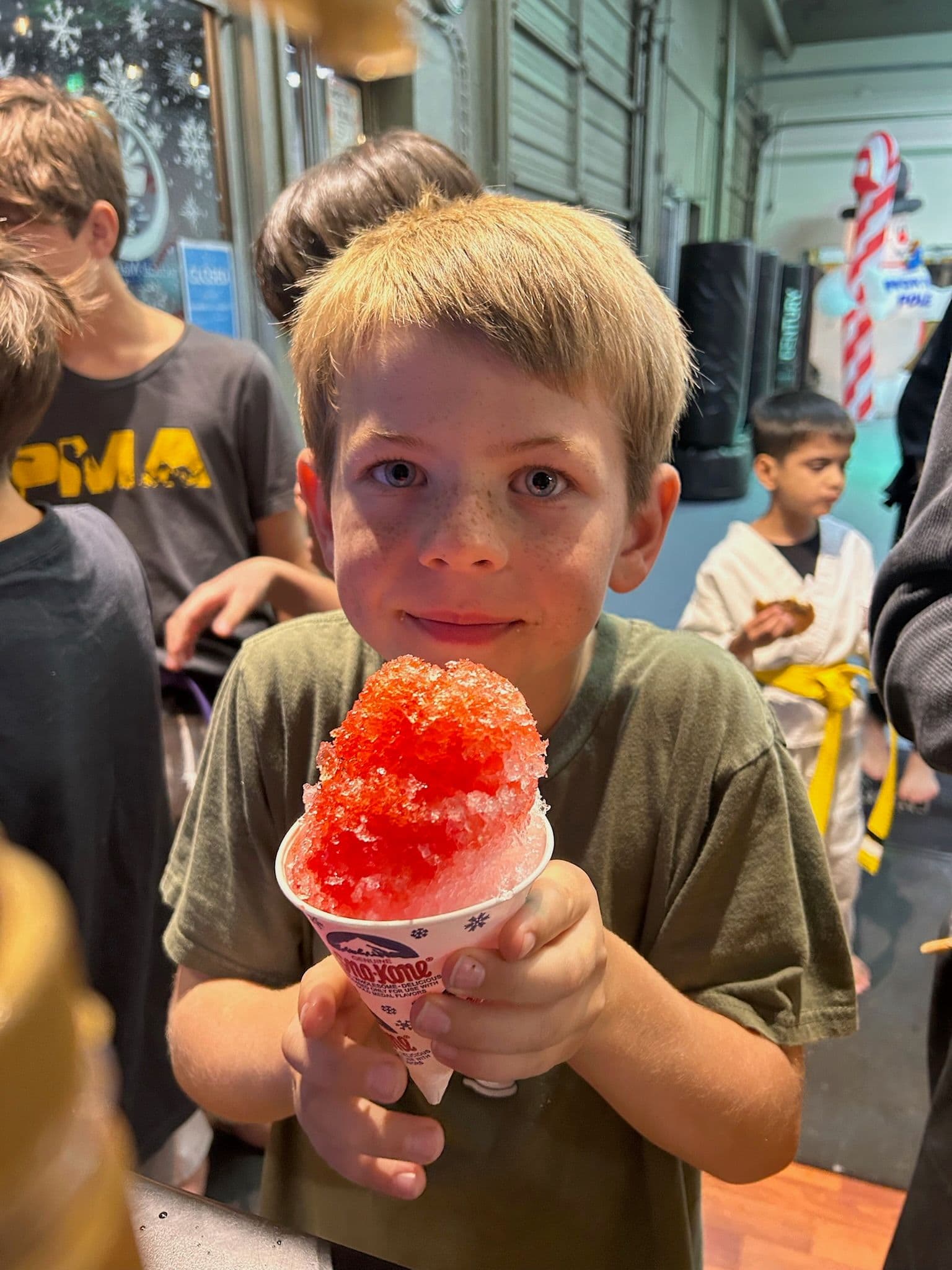 A kid enjoying a treat at a PMA Ninja Night